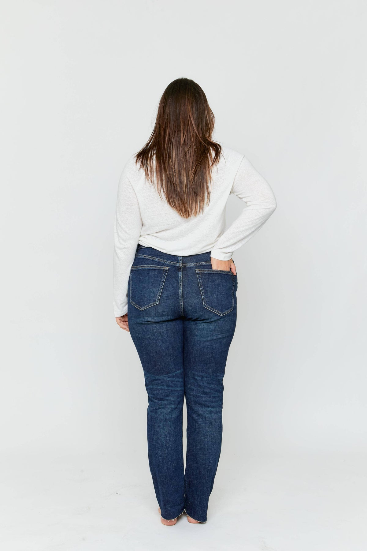 Oliver Logan Crosby Mid Rise Relaxed Taper Jean in standard wash, showing the casual fit and classic denim details.