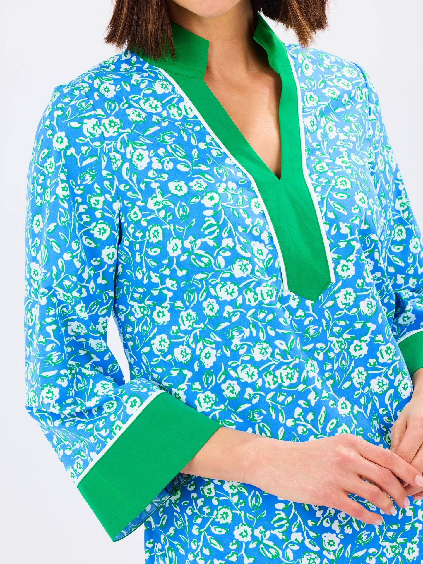 Mary Square Brenda Meadowline Dress displayed on a hanger with floral patterns and flowing fabric.