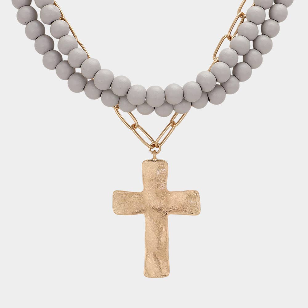 Hammered metal cross pendant with wood bead necklace, jewelry by Sensibling Corp., featuring rustic cross and natural beads.