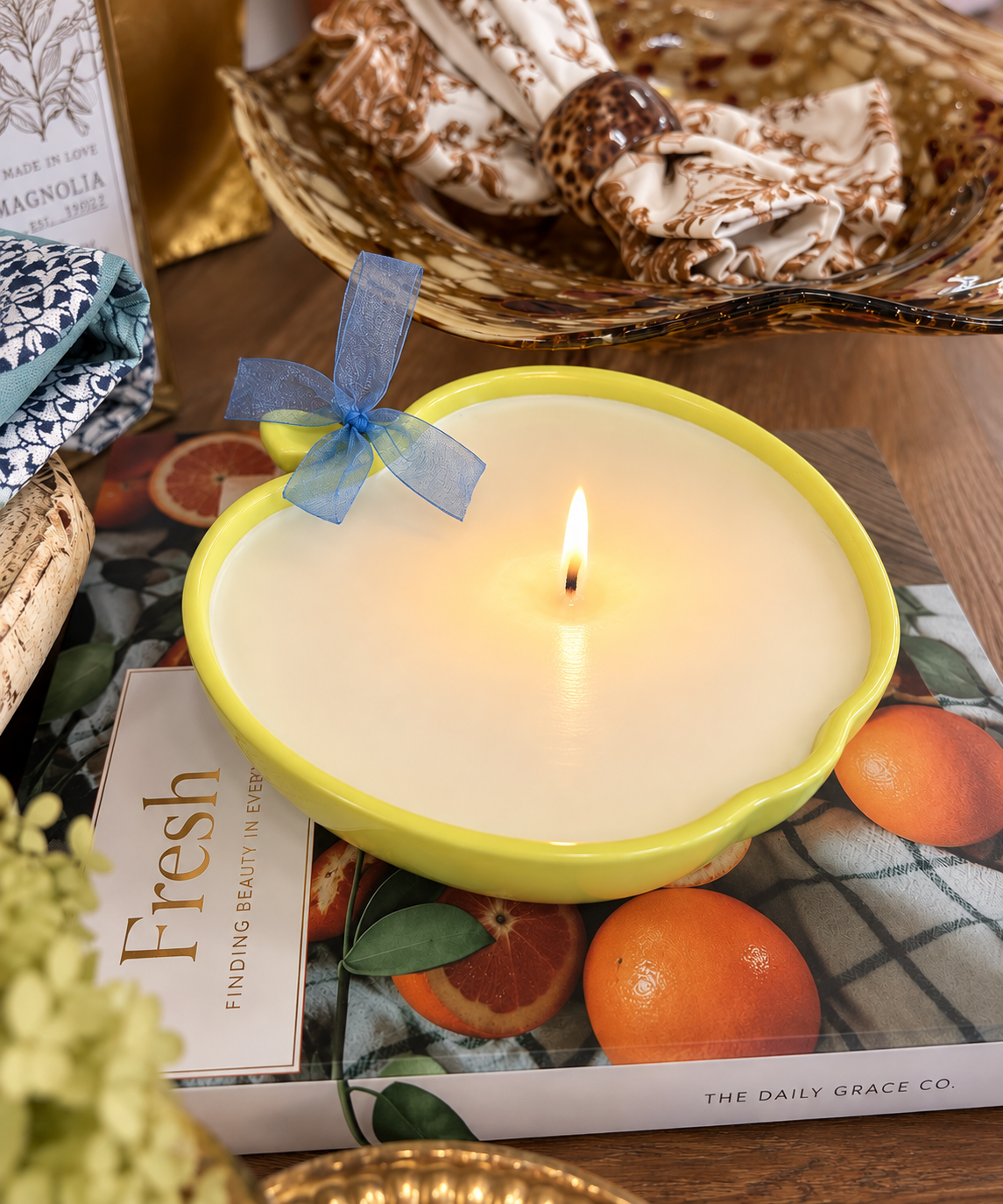 First Pick candle in a chartreuse apple vessel with blue bow