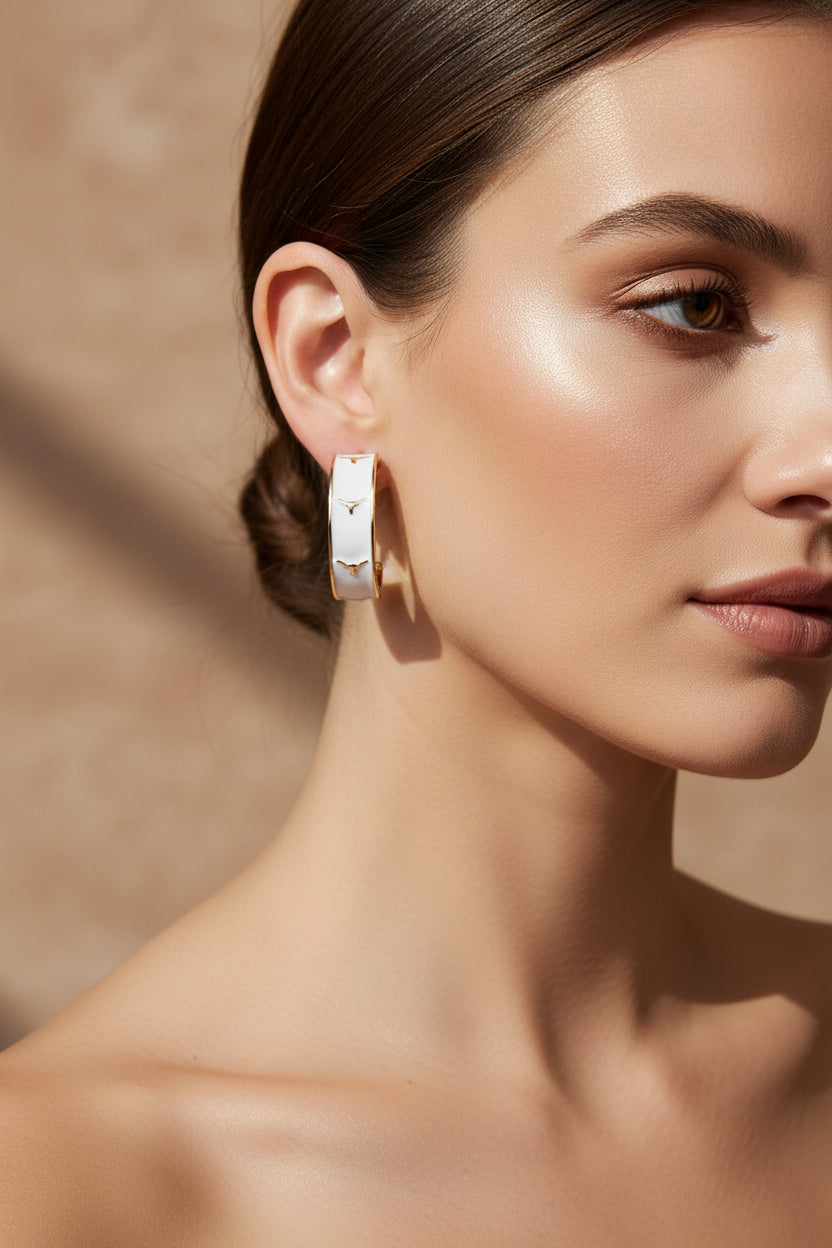 White enamel Texas Longhorns logo hoop earrings by Canvas Style, showcasing bold Longhorn design and shiny metal hoops.