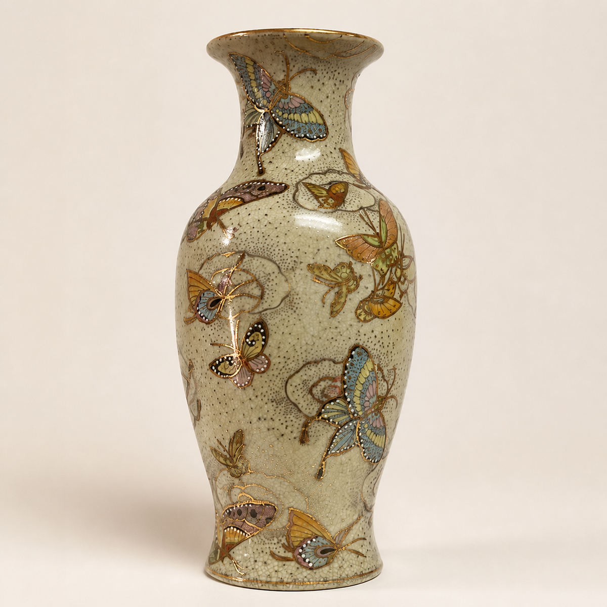Crackle-glazed butterfly motif baluster vase on an ivory studio background