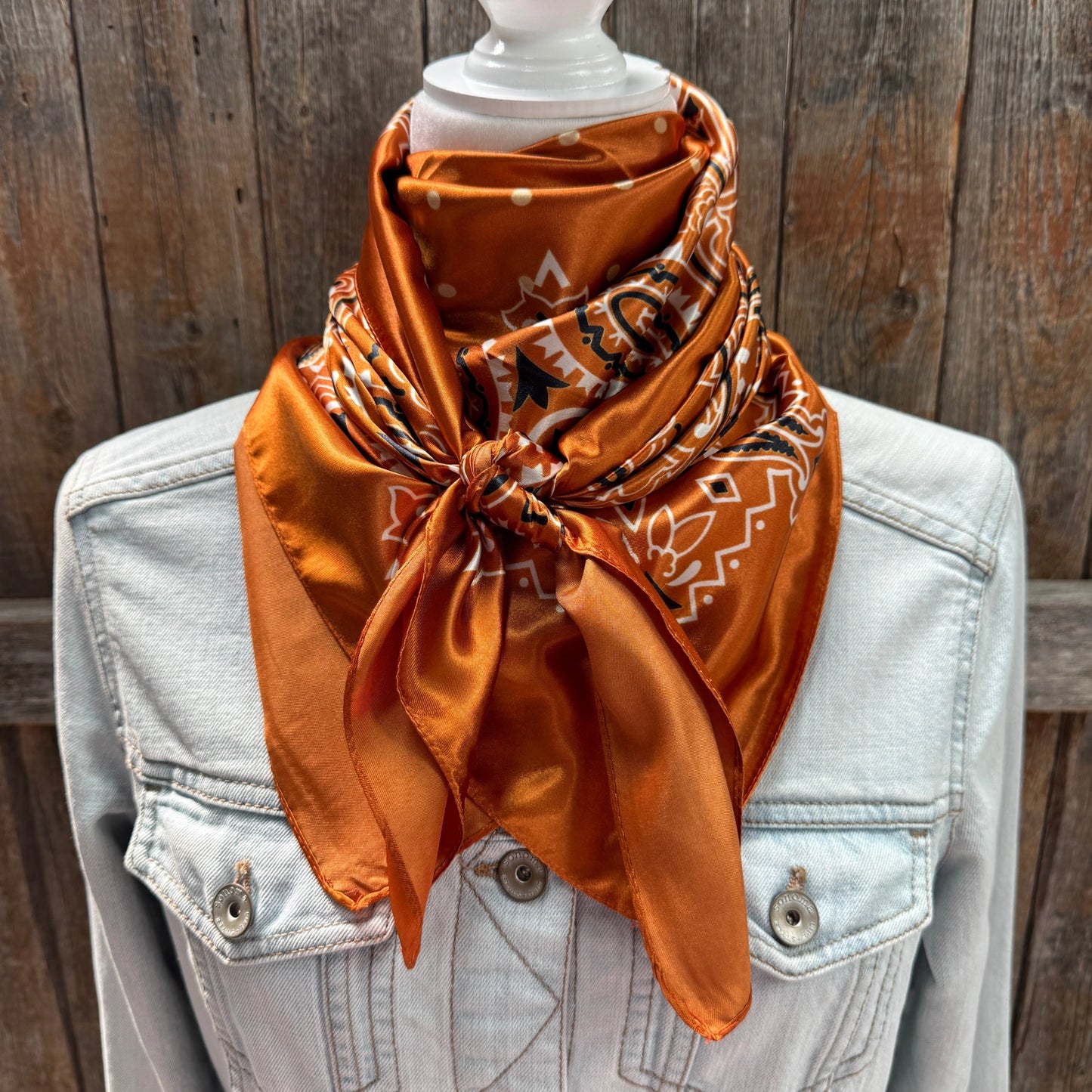 The Harvest Rust Square Scarf tied at the neck