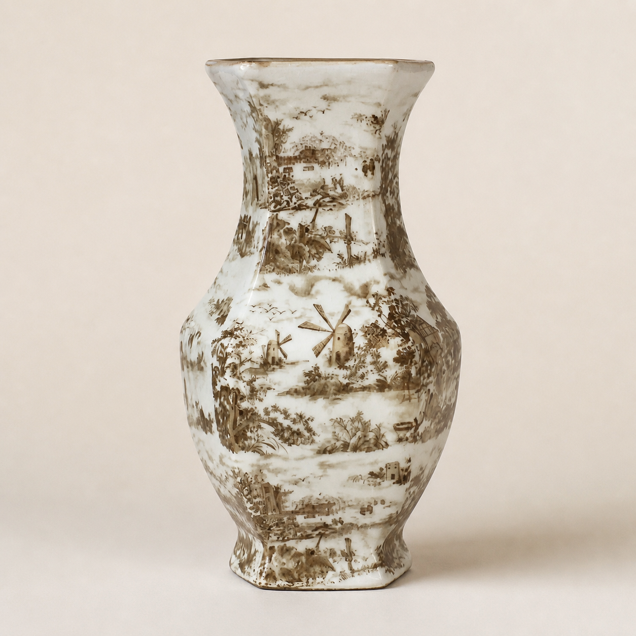Hexagonal sepia transferware baluster vase on an ivory studio background