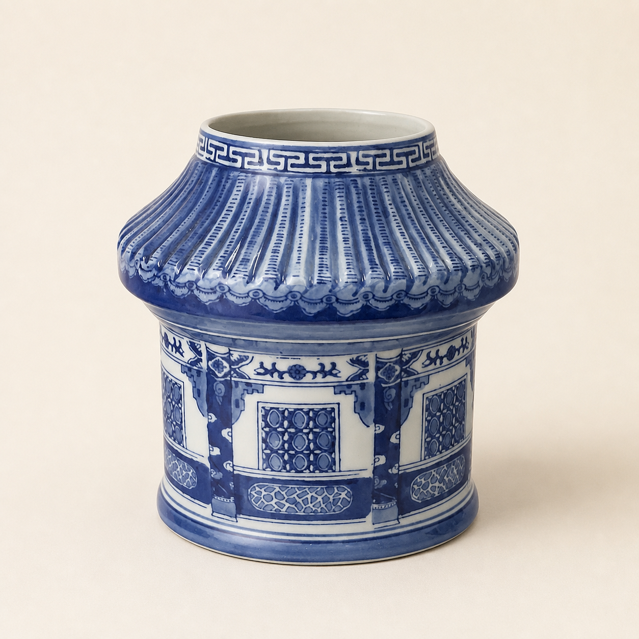 Pagoda-form blue and white vase on an ivory studio background