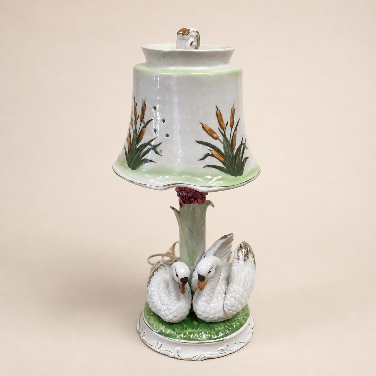 Figural ceramic swan lamp on an ivory studio background