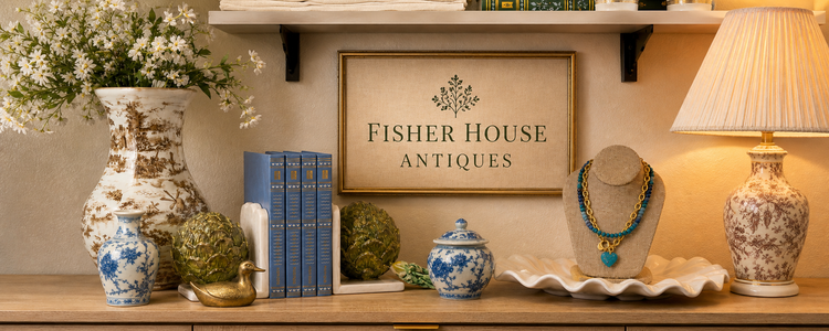 Fisher House Antiques vignette with blue-and-white porcelain, vintage books, decorative objects, and jewelry