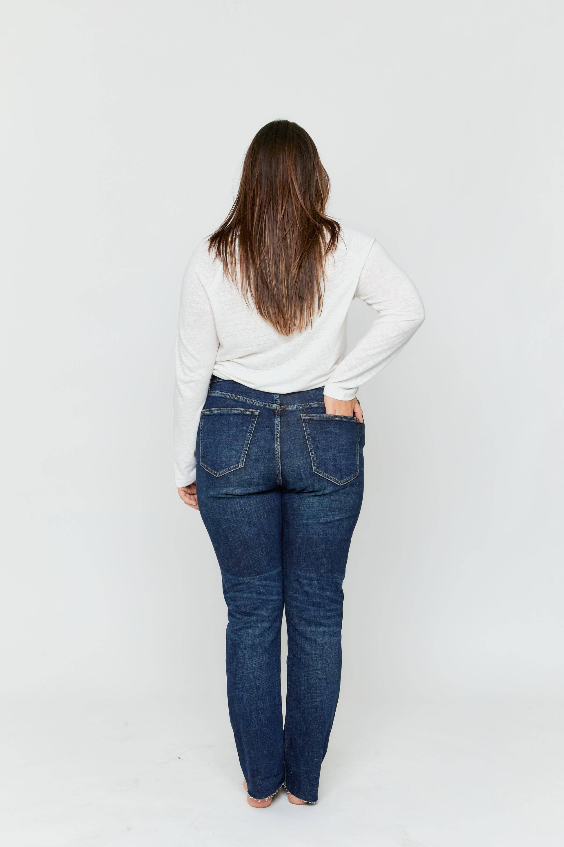 Oliver Logan Crosby Mid Rise Relaxed Taper Jean in standard wash, showcasing denim bottoms with a relaxed fit and tapered leg design.
