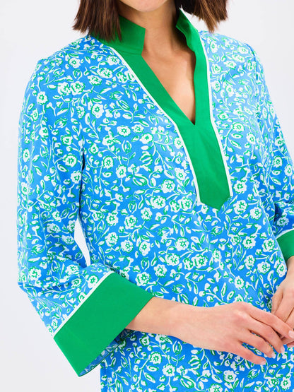 Mary Square Brenda Meadowline Dress displayed on a hanger with floral patterns and flowing fabric.