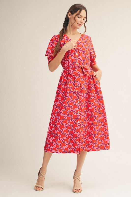 Jodiful Sienna Sunset Abstract Midi Dress with flowing fabric and vibrant sunset-inspired patterns, perfect for elegant occasions.