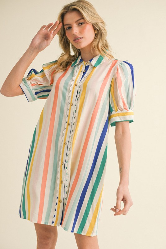 Jodiful Caroline Riviera Stripe Shirt Dress hangs on a hanger, featuring blue and white horizontal stripes and a collar.