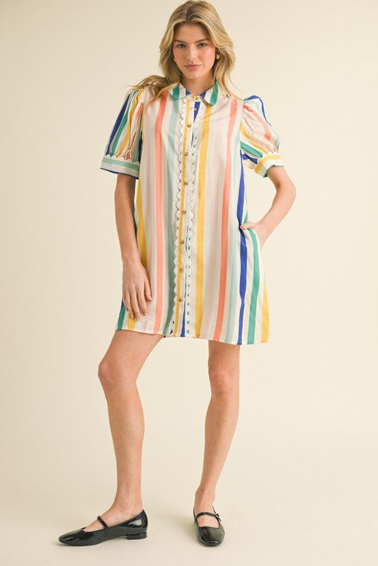 Jodiful Caroline Riviera Stripe Shirt Dress displayed on a hanger, featuring blue and white horizontal stripes and a classic shirt dress style.