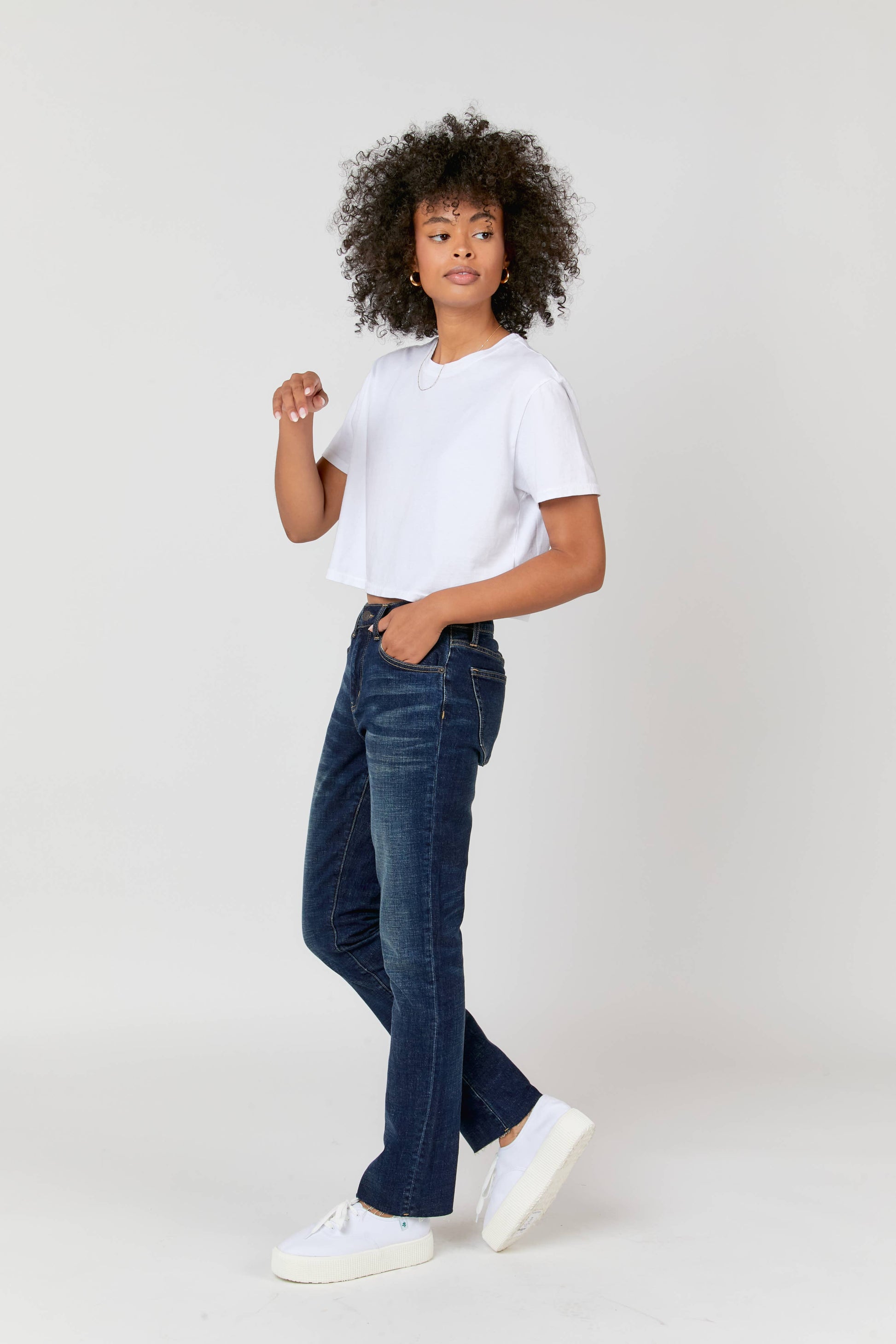 Oliver Logan Crosby Mid Rise Relaxed Taper Jean in standard wash, showing the relaxed fit and classic denim texture.