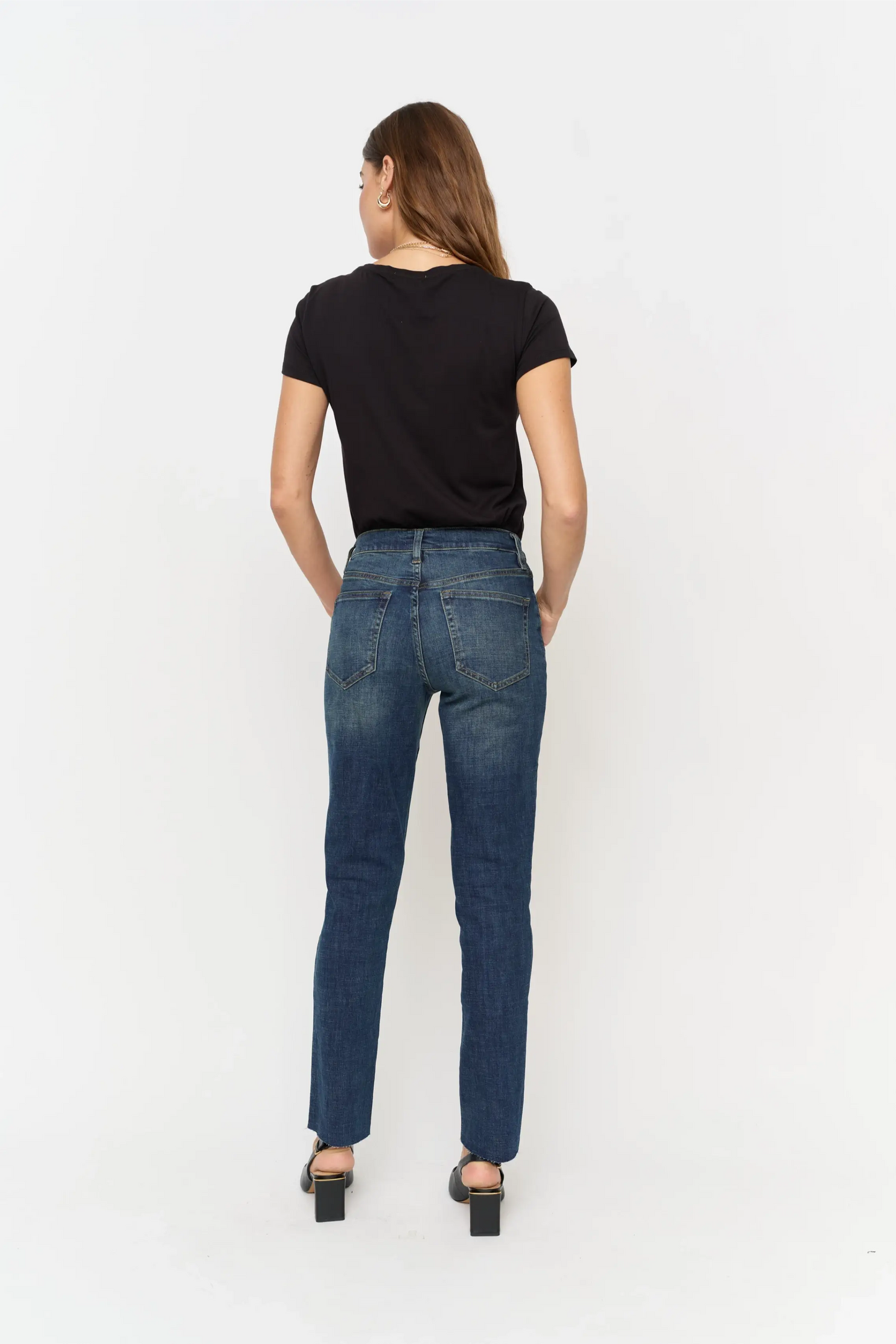 Oliver Logan Crosby mid-rise relaxed taper jeans in standard wash, showing the denim fabric and classic five-pocket design.