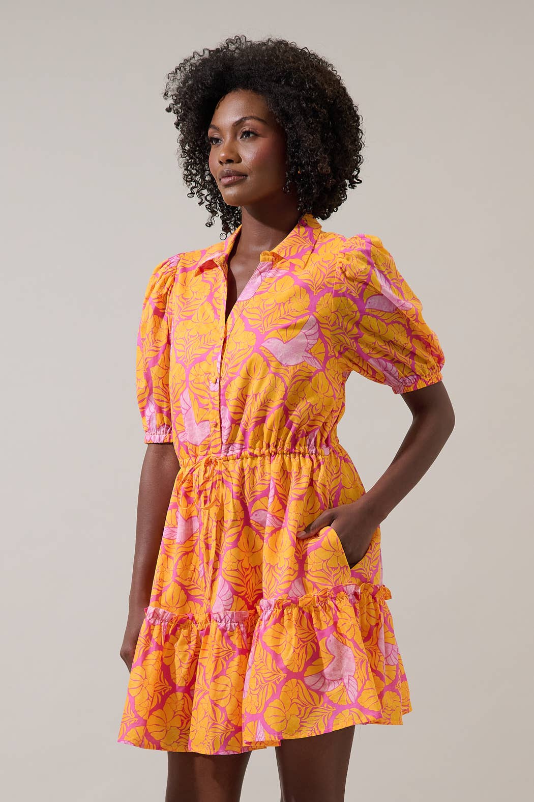 Sugarlips Jaidy Stacie button-down mini dress displayed on a hanger, featuring a fitted silhouette and long sleeves.