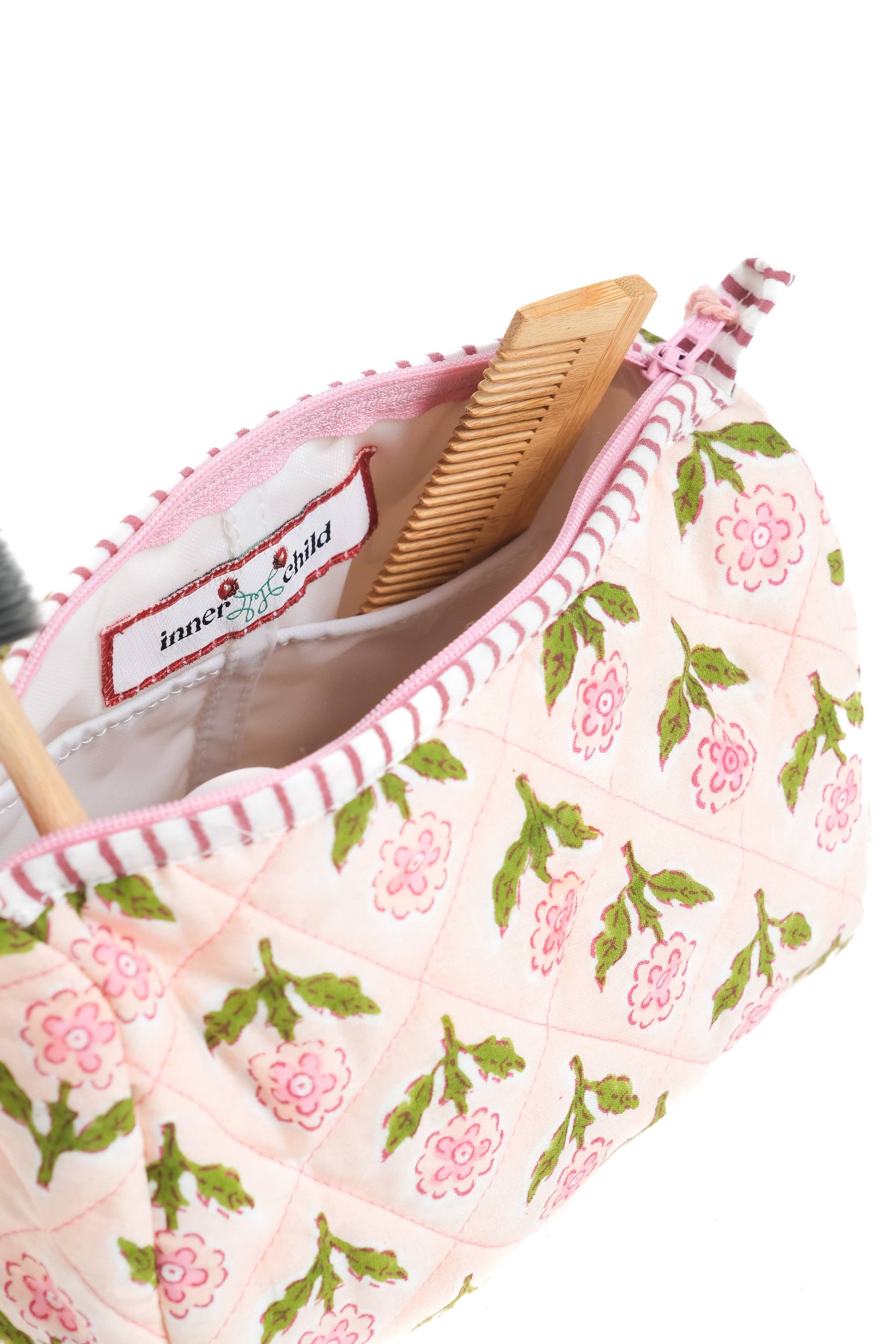 Inner Child Mona Blockprint makeup bag in pink with a geometric blockprint pattern, featuring a zipper closure and compact design.