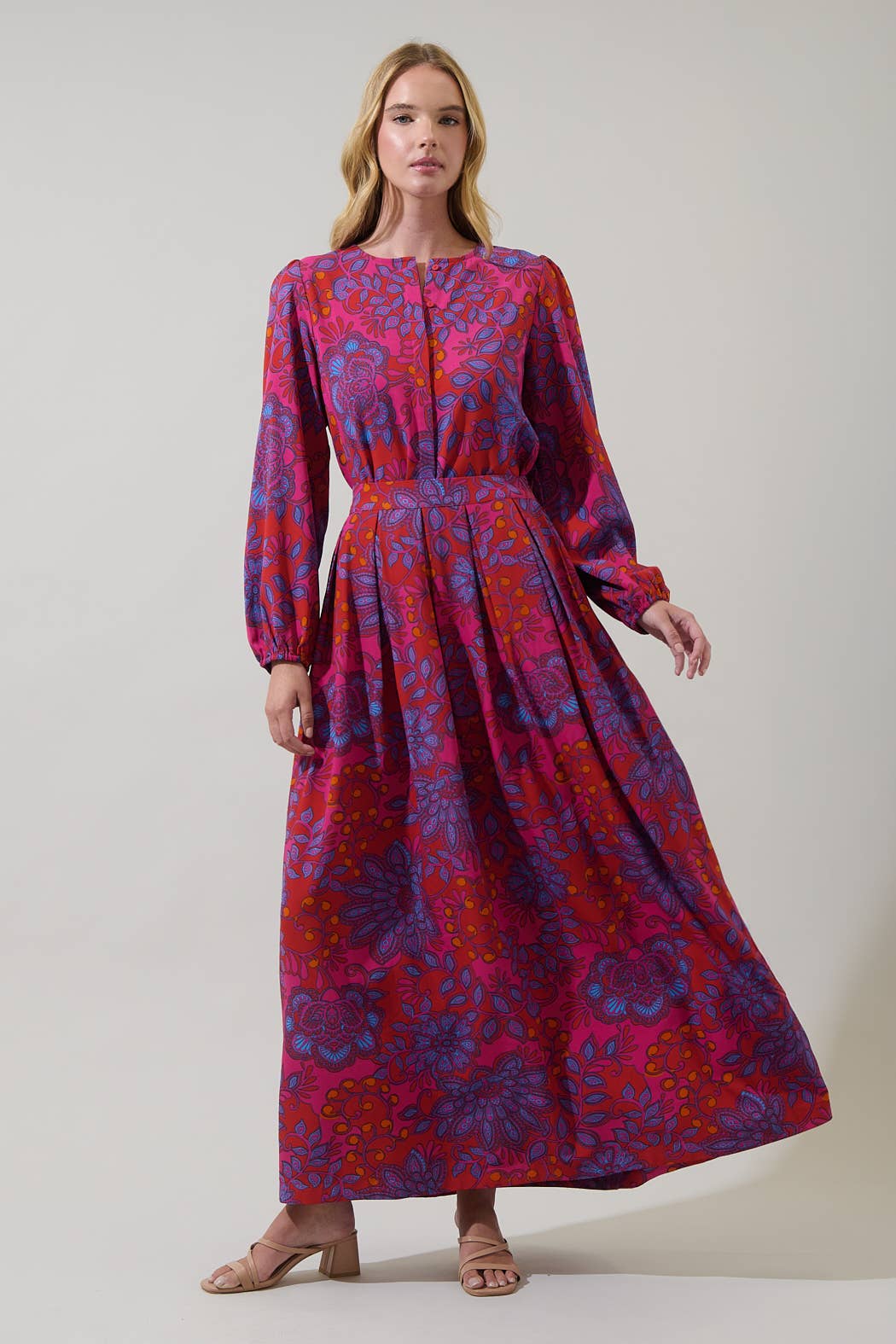 Sugarlips Darret Floral Lucie pleated maxi skirt in vibrant fuchsia with colorful floral patterns and flowing pleats.