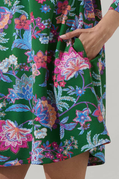 Sugarlips Elara Emerald Ruelle Mini Dress displayed on hanger with intricate details and vibrant emerald color.