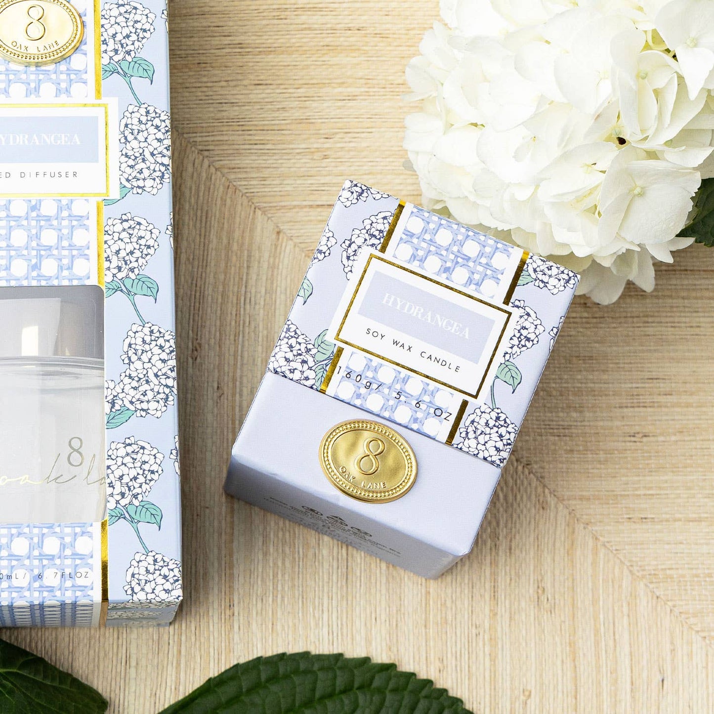 A white hydrangea-shaped candle from 8 Oak Lane's Lillian Hydrangea Candle collection, with detailed flower petal design.
