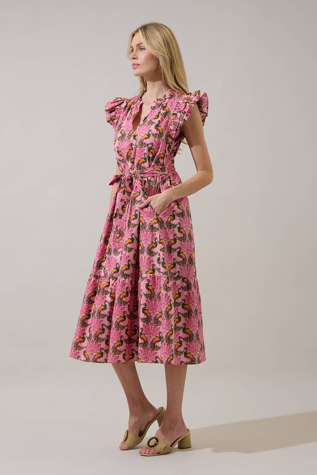 Sugarlips Peacock Bay Sita Ruffle Midi Dress with floral pattern, flowy fabric, and ruffled neckline on a hanger.