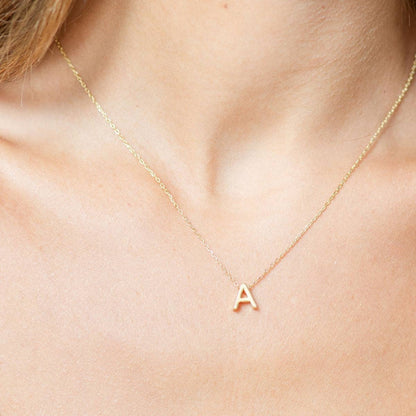 Gold initial necklace from Splendid Iris featuring a personalized pendant on a delicate chain.