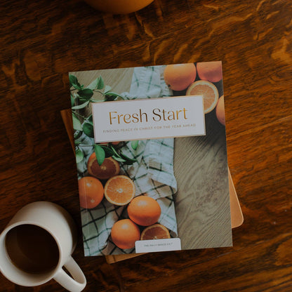 Fresh Start Devotional by The Daily Grace Co, open devotional book with pages featuring inspiring text and decorative design.