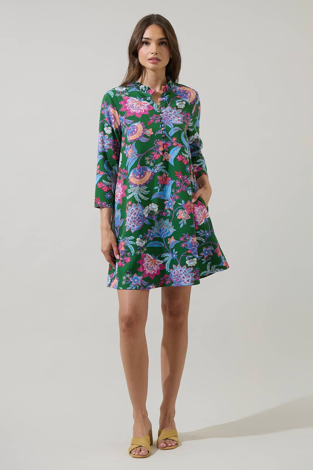 Sugarlips Elara Emerald Ruelle Mini Dress, vibrant green dress with ruffle details and fitted silhouette, displayed on a mannequin.