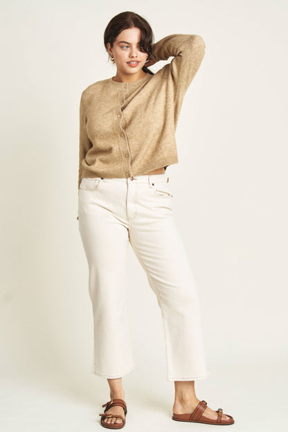 Oliver Logan Addington ankle crop mid-rise jeans in ecru, showing the light-colored denim with a slim fit and rolled hems.
