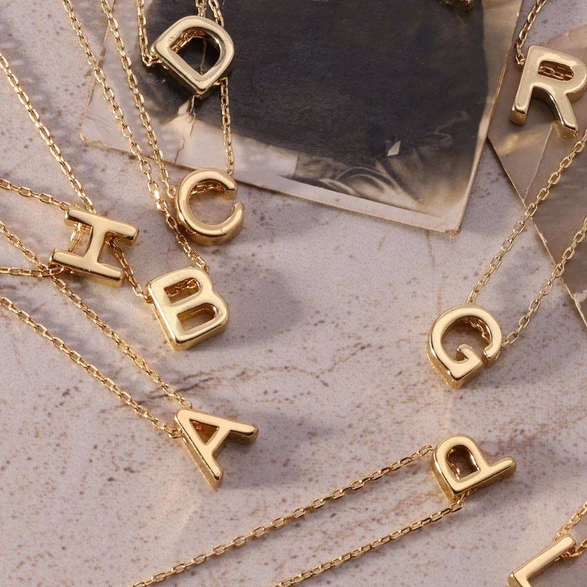 Gold initial necklace with a sleek pendant featuring a personalized letter, crafted by Splendid Iris jewelry brand.