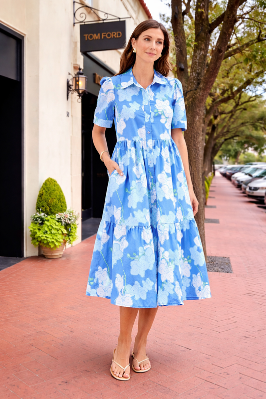 Chic blue Jema Orchid Reverie midi dress by Mary Square displayed on a mannequin. Elegant, flowing dress with floral details.