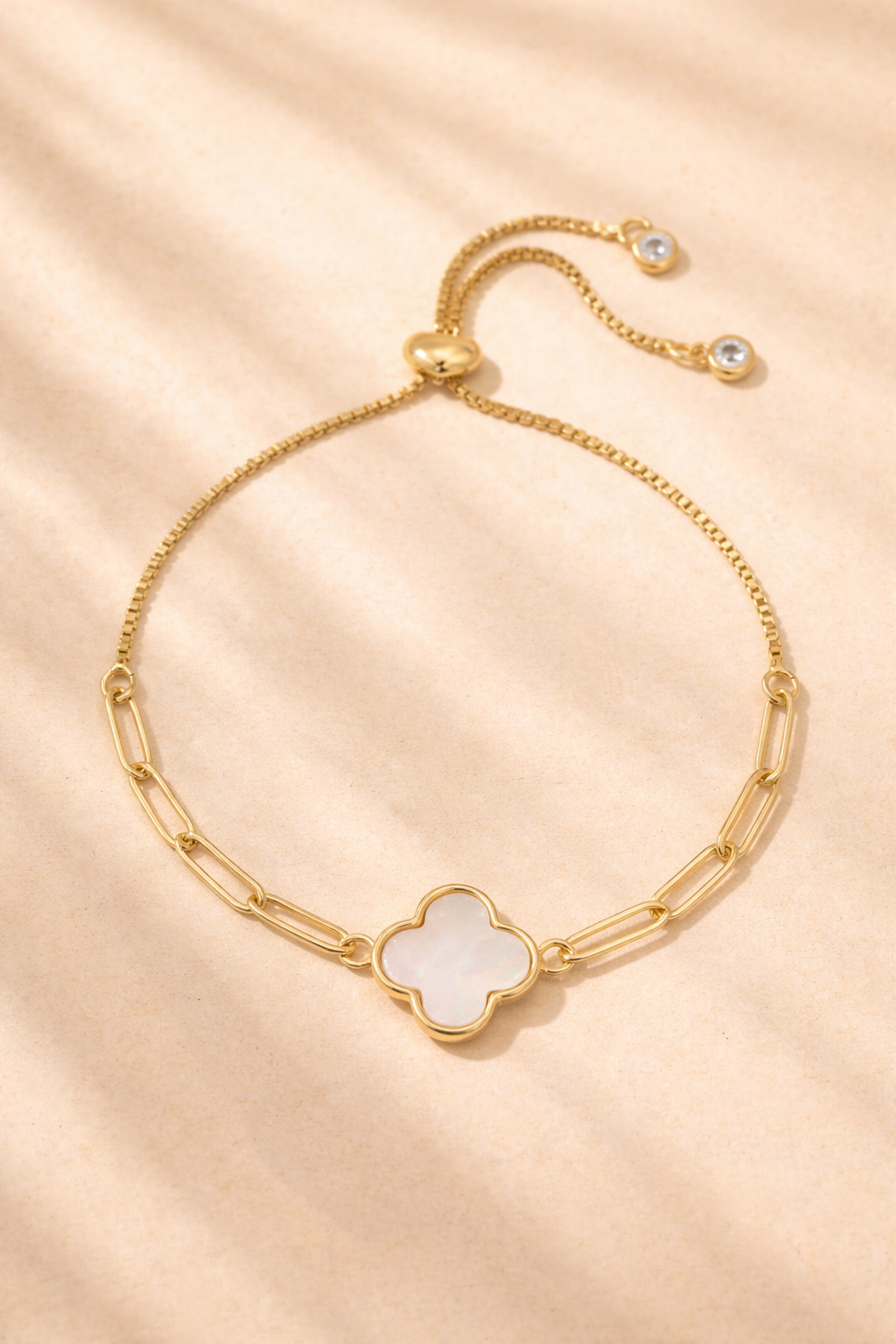 Gold Quatrefoil Pulley Bracelet with clover charm by Splendid Iris, showcasing elegant jewelry design with intricate detail.