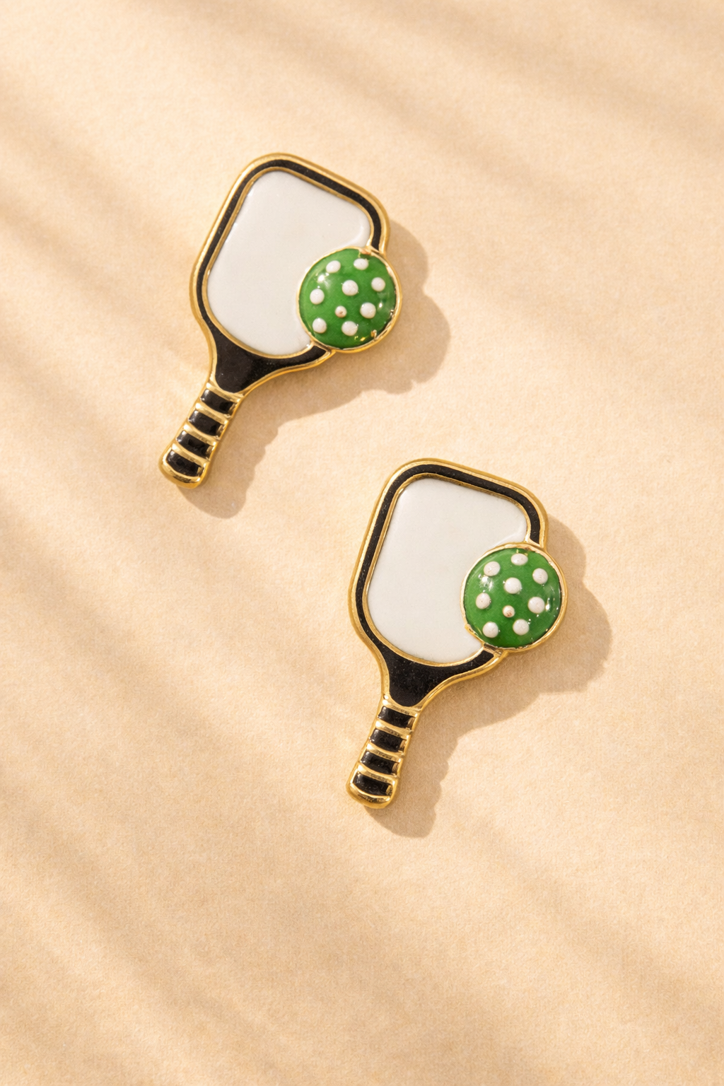 Close-up of Canvas Style pickleball paddle stud earrings, showcasing silver jewelry with detailed pickleball paddle design.