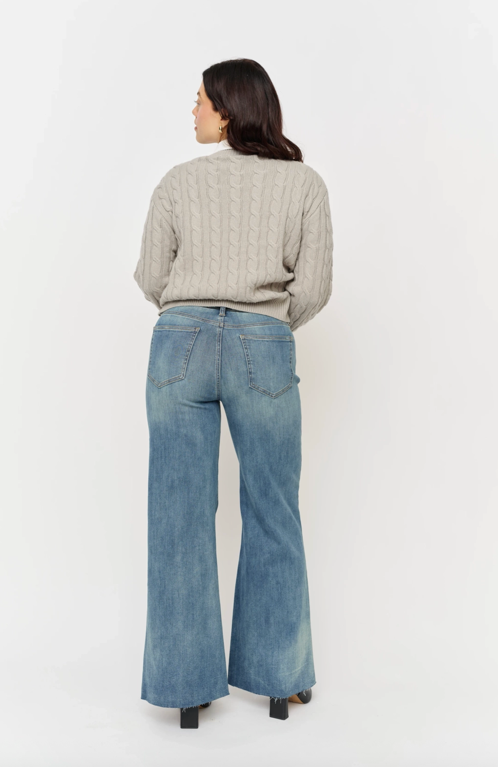 Oliver Logan Crawford vintage denim bottoms featuring mid-rise fit, sculpted waist, and wide-leg design in classic blue denim.