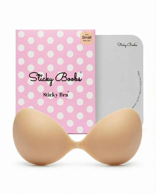 Sticky Boobs adhesive push-up backless strapless bra standing with cups touching the ground, packaging box visible in front view.