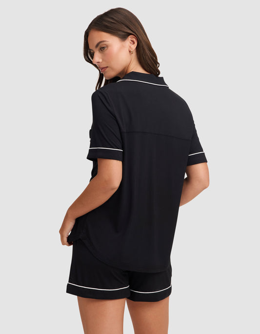 Women's black bamboo stretch-knit classic pajama set by Cozy Earth, featuring short sleeves and comfortable relaxed fit.