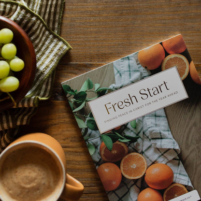 Fresh Start Devotional by The Daily Grace Co, featuring an open devotional book with inspiring pages and a floral cover.