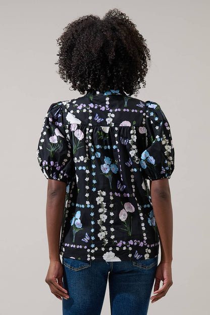 Sugarlips Trevis Noir Garden Blouse, stylish black top with floral pattern, lightweight fabric, and feminine design.