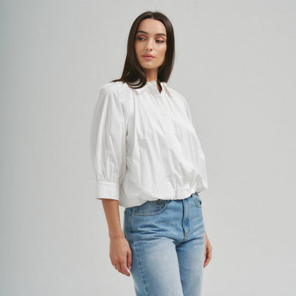 Able ivory 3/4 sleeve bubble hem blouse with relaxed silhouette