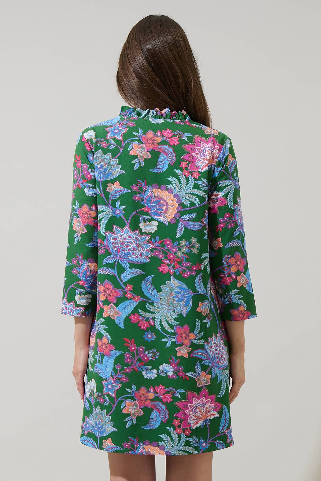 Sugarlips Elara Emerald Ruelle Mini Dress featuring a vibrant emerald green color, fitted silhouette, and stylish design.