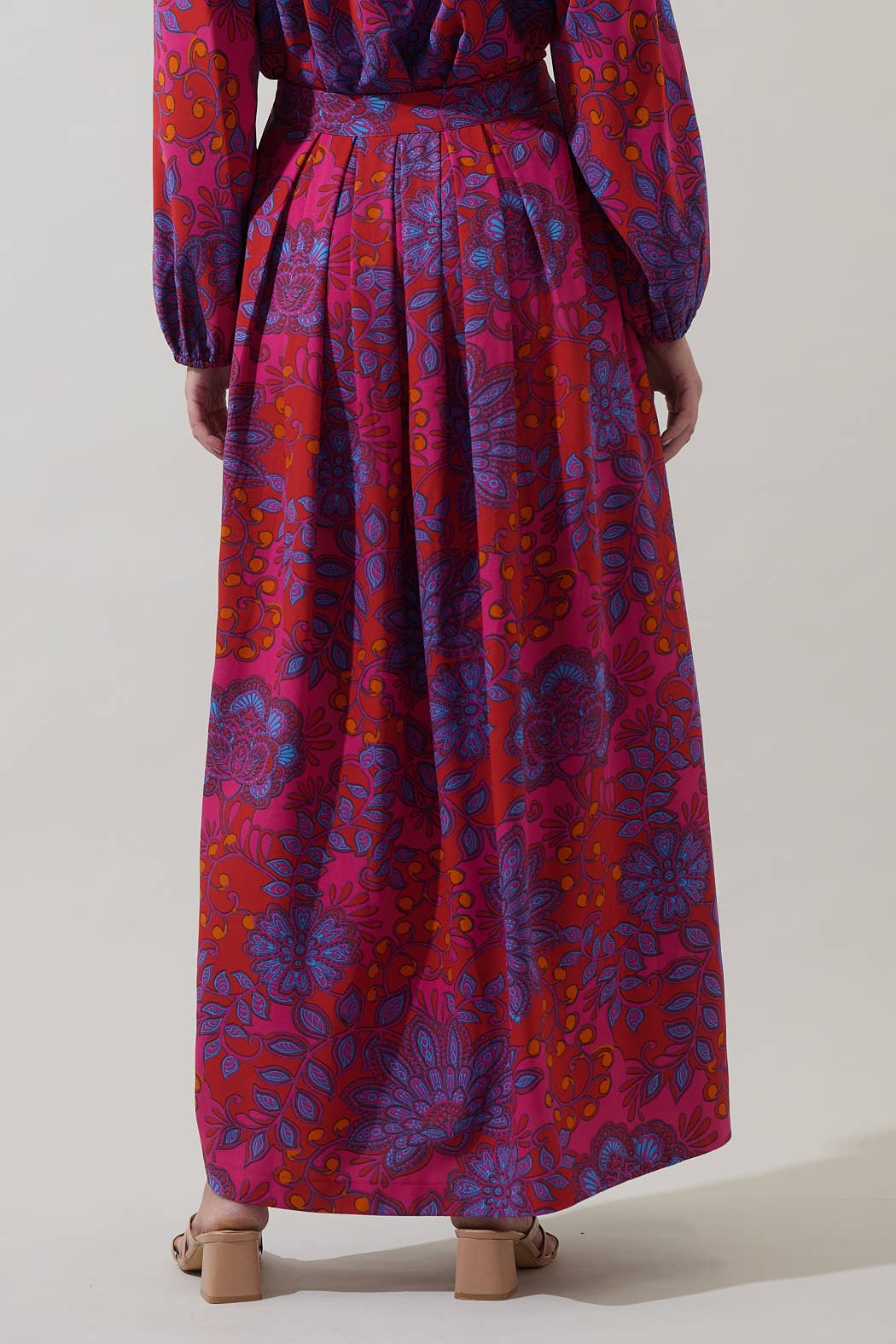 Sugarlips Darret Floral Lucie pleated maxi skirt in vibrant fuchsia multi, showcasing flowing fabric and colorful floral pattern.