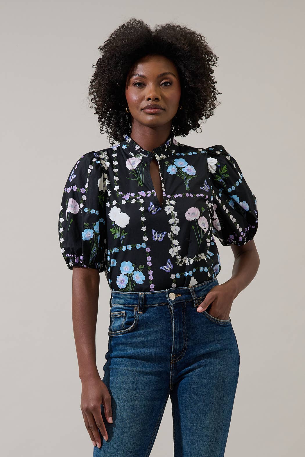 Sugarlips Trevis Noir Garden Blouse, stylish women's top with floral design and lightweight fabric, displayed on a hanger.