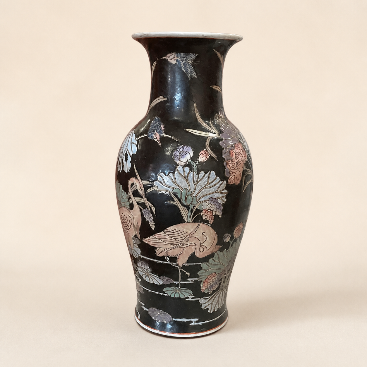 Large black-ground crane and lotus vase on an ivory studio background
