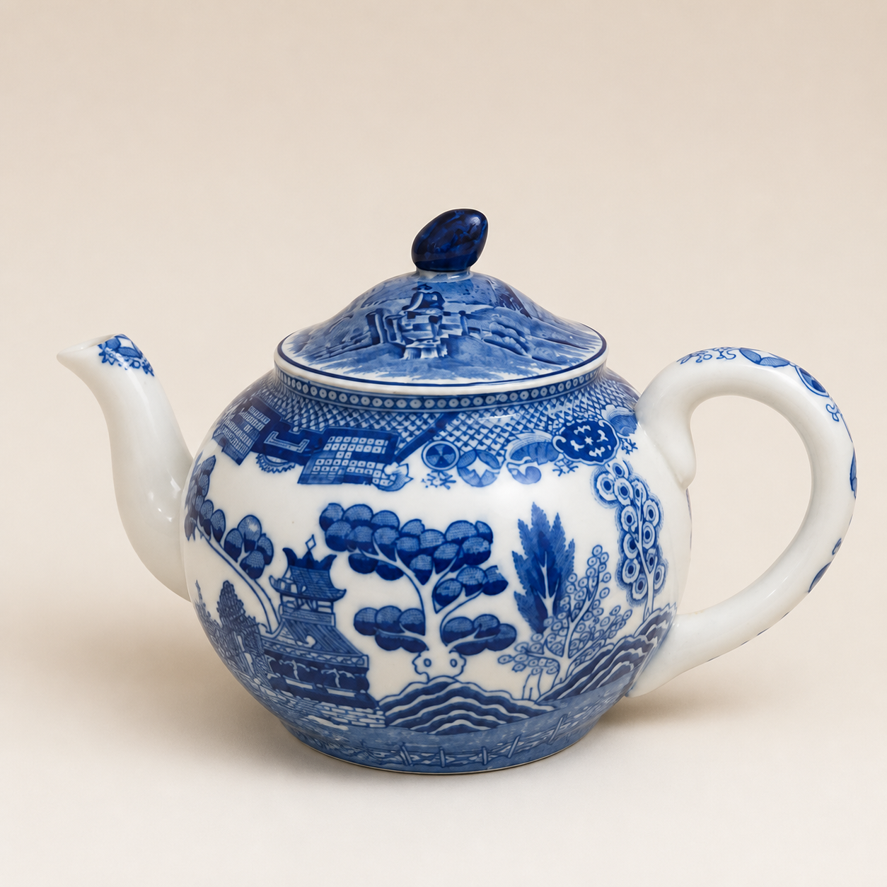 Blue Willow teapot on an ivory studio background