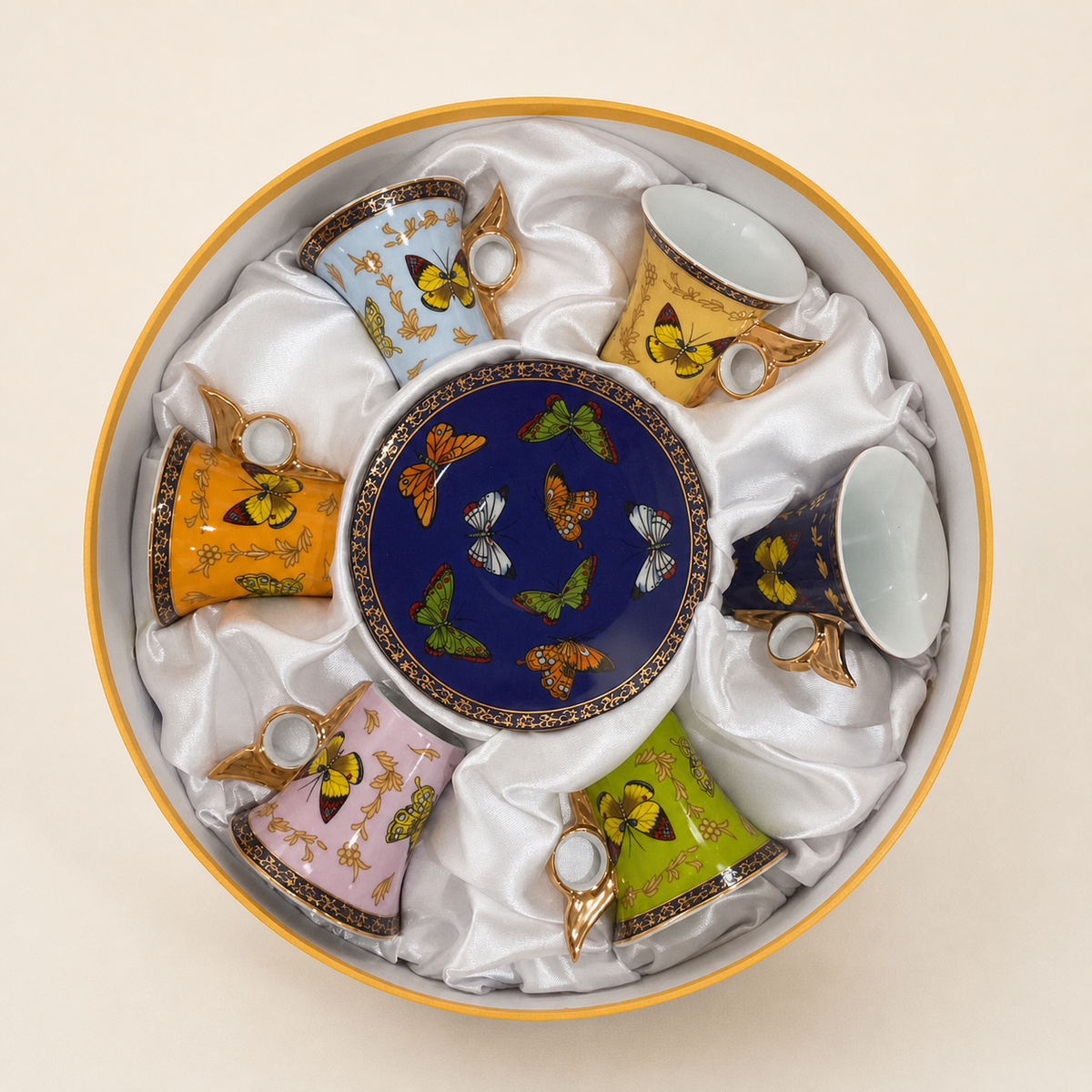 Boxed set of six butterfly-pattern demitasse cups on an ivory studio background