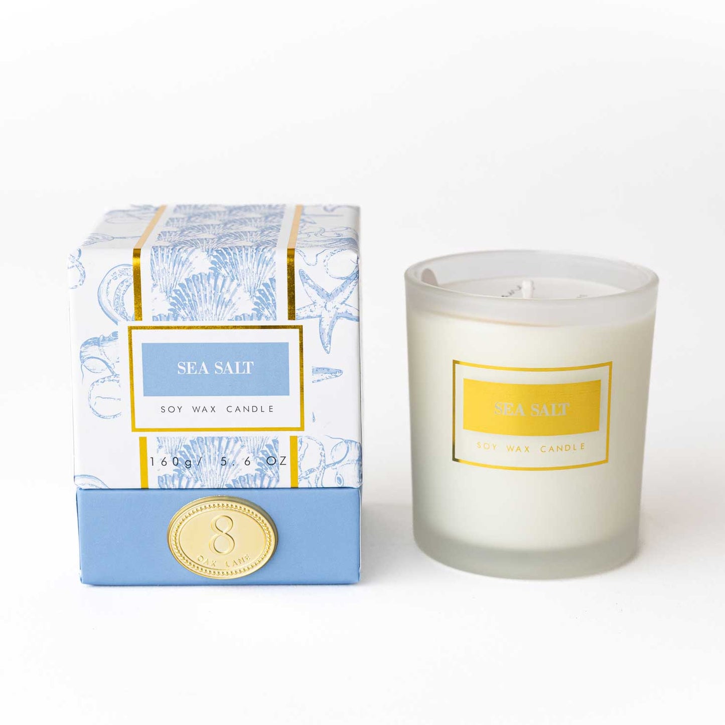 8 Oak Lane sea salt scented candle in a boxed candle container, showcasing a white candle with a minimalist design.
