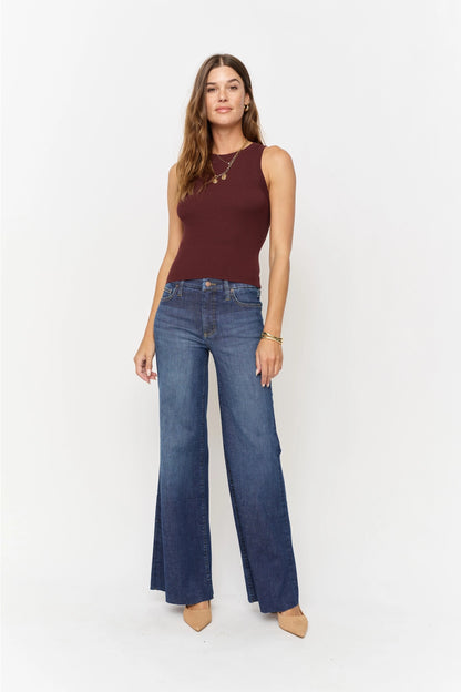 Oliver Logan Crawford mid-rise fitted wide-leg dark worn jeans, showing the relaxed fit and stylish distressed denim details.