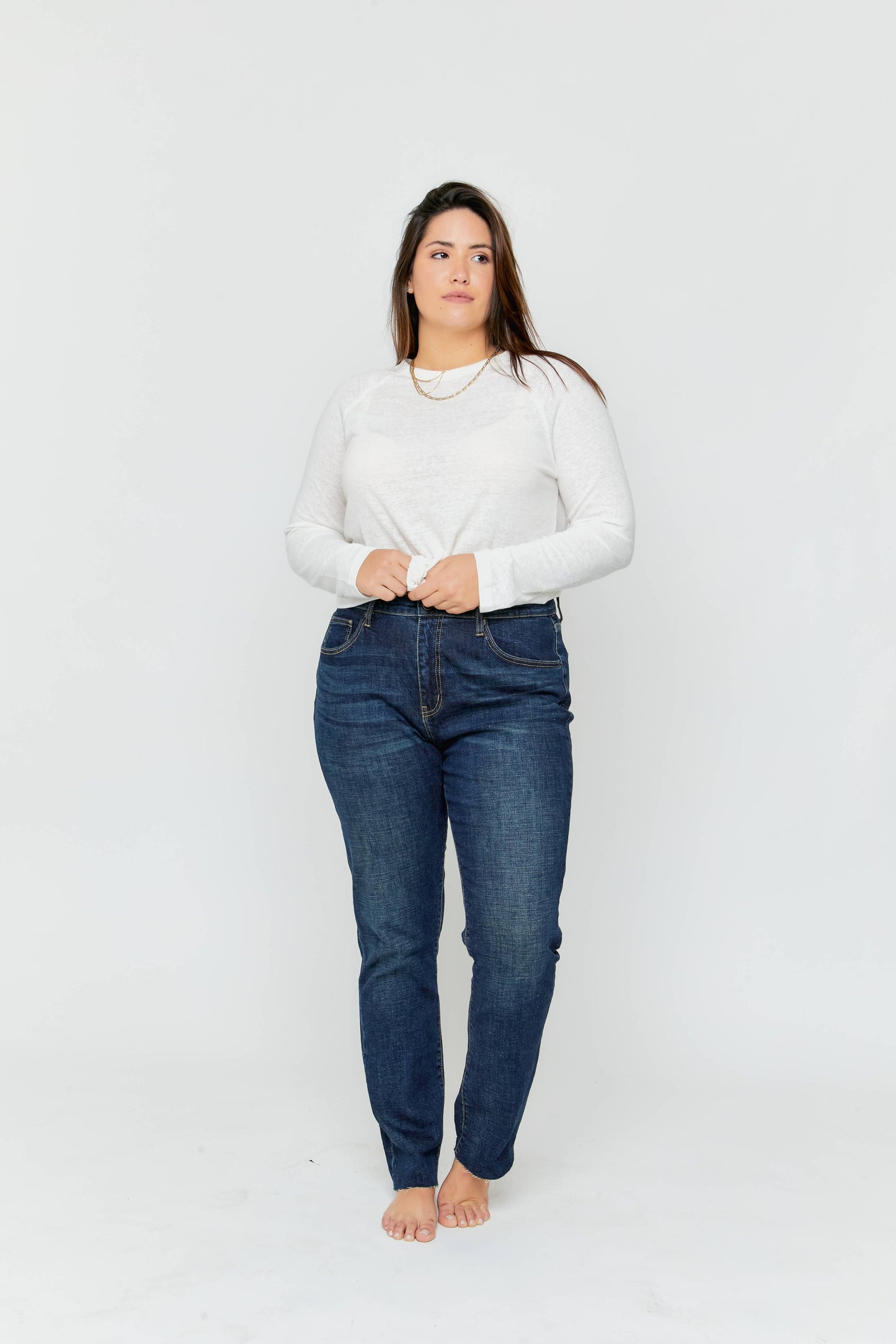 Oliver Logan Crosby Mid Rise Relaxed Taper Jean in standard wash, showing the casual fit and denim texture.