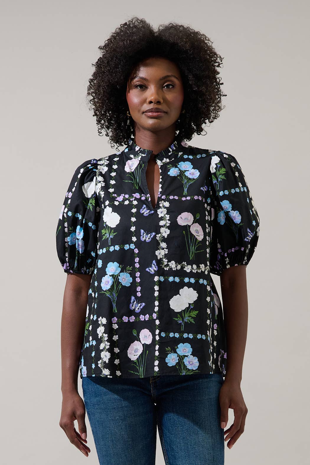 Sugarlips Trevis Noir Garden Blouse, stylish black top with floral pattern, displayed on a hanger.