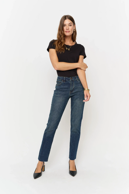Oliver Logan Crosby Mid Rise Relaxed Taper Jean in standard wash, showcasing the denim's fit and classic style on a model.