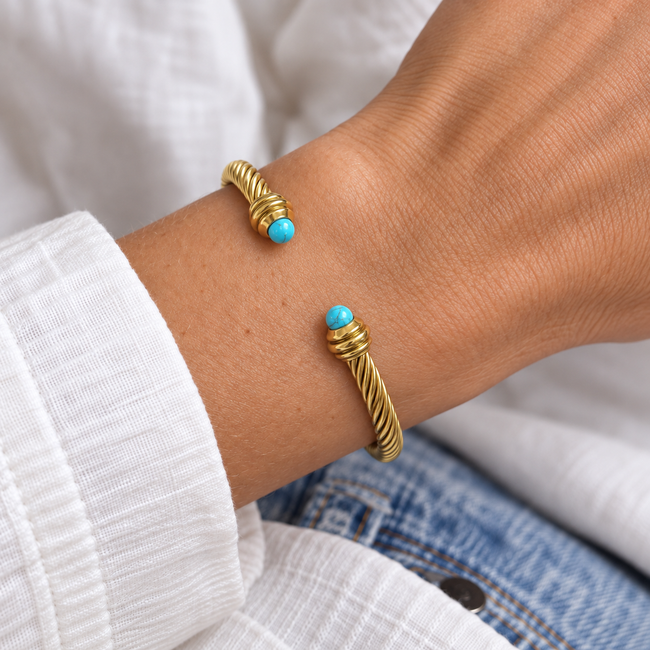 Turquoise tipped gold rope cuff on wrist